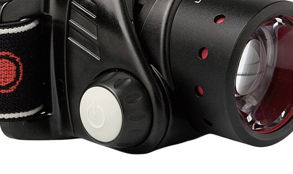 Stirnlampe mit schwarzem Gehäuse, rotem Reflektor und weißem Ein-/Ausschalter.