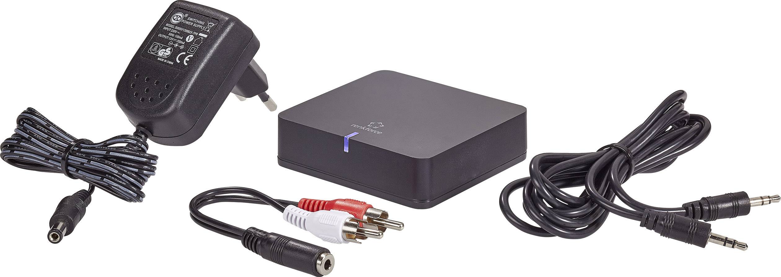 Netzteil, RCA-Audiokabel und ein schwarzes elektronisches Gerät mit LED-Anzeige auf weißem Hintergrund.