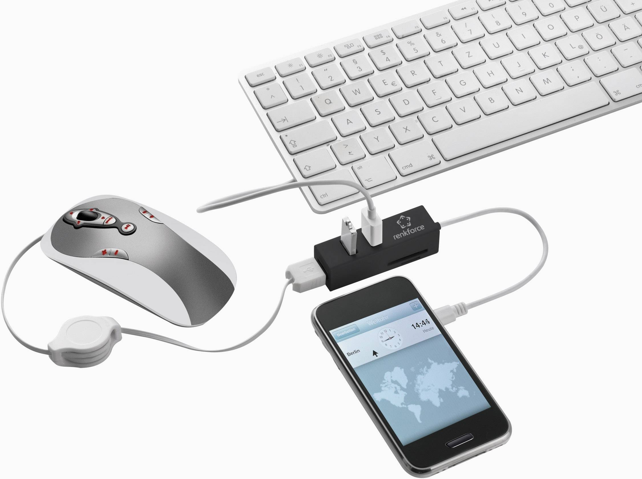 Eine Computermaus und -tastatur sind mit einem Smartphone verbunden, das eine Weltkarte auf dem Bildschirm zeigt.