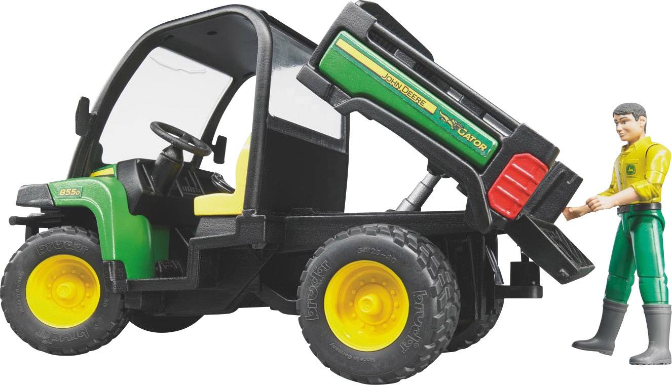 Spielzeugtraktor mit Anhänger kippt Ladefläche; Figur eines Arbeiters steht daneben.