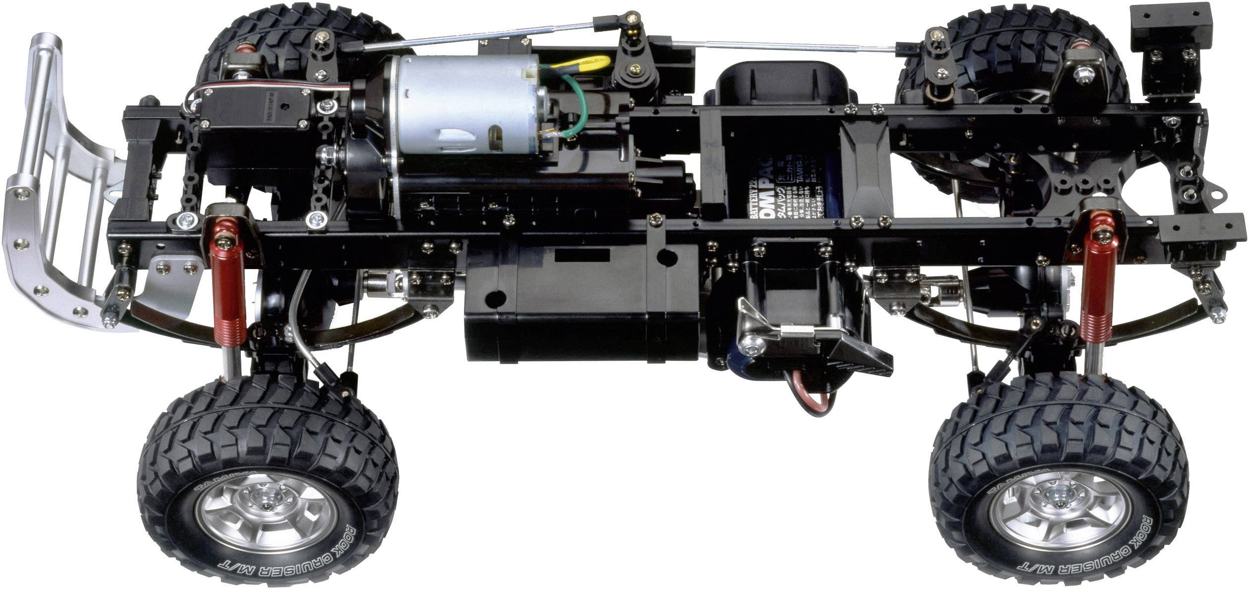 Ein RC-Autofahrgestell mit offenem Rahmen zeigt Motor, Achsen und federnde Aufhängung. Ideal für Modellbau-Enthusiasten.