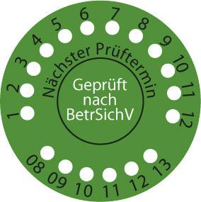 Grünes Prüfsiegel mit der Aufschrift 'Geprüft nach BetrSichV'. Die Zahlen 1 bis 12 sind kreisförmig angeordnet.