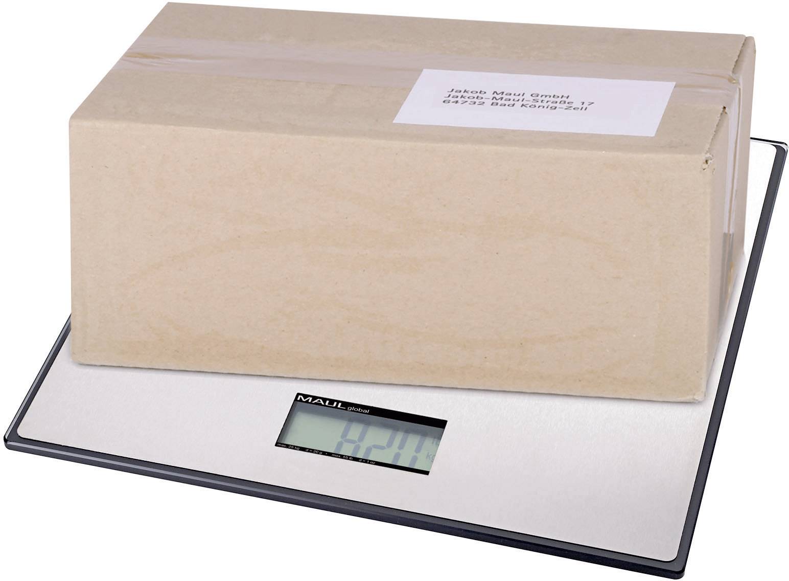Ein Kartonpaket liegt auf einer digitalen Waage. Die Anzeige zeigt '4.28 kg'. Oben auf dem Paket ist ein Adressetikett sichtbar.