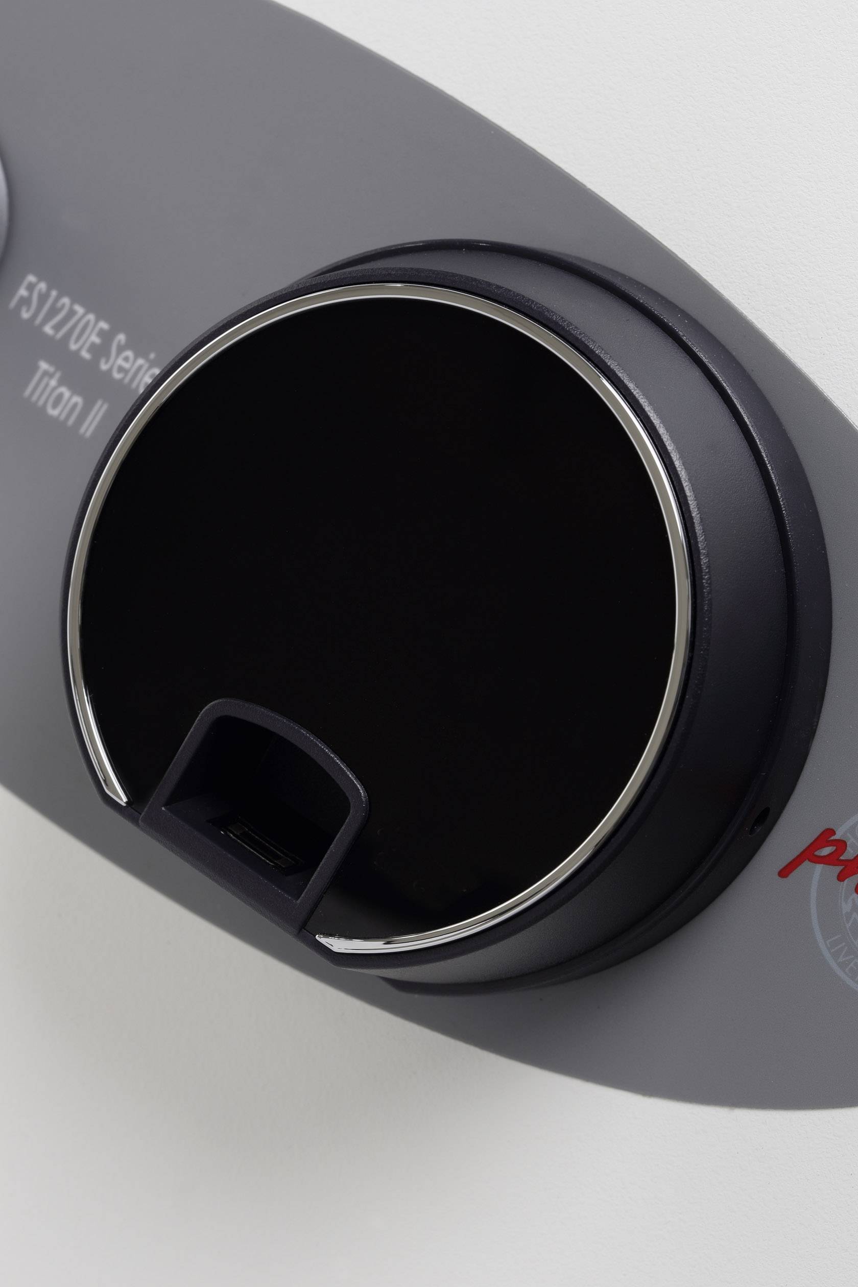 Schwarzes, rundes Zahlenschloss auf grauem Hintergrund, Teil eines Safes. Das Schloss hat eine kleine Öffnung unten.