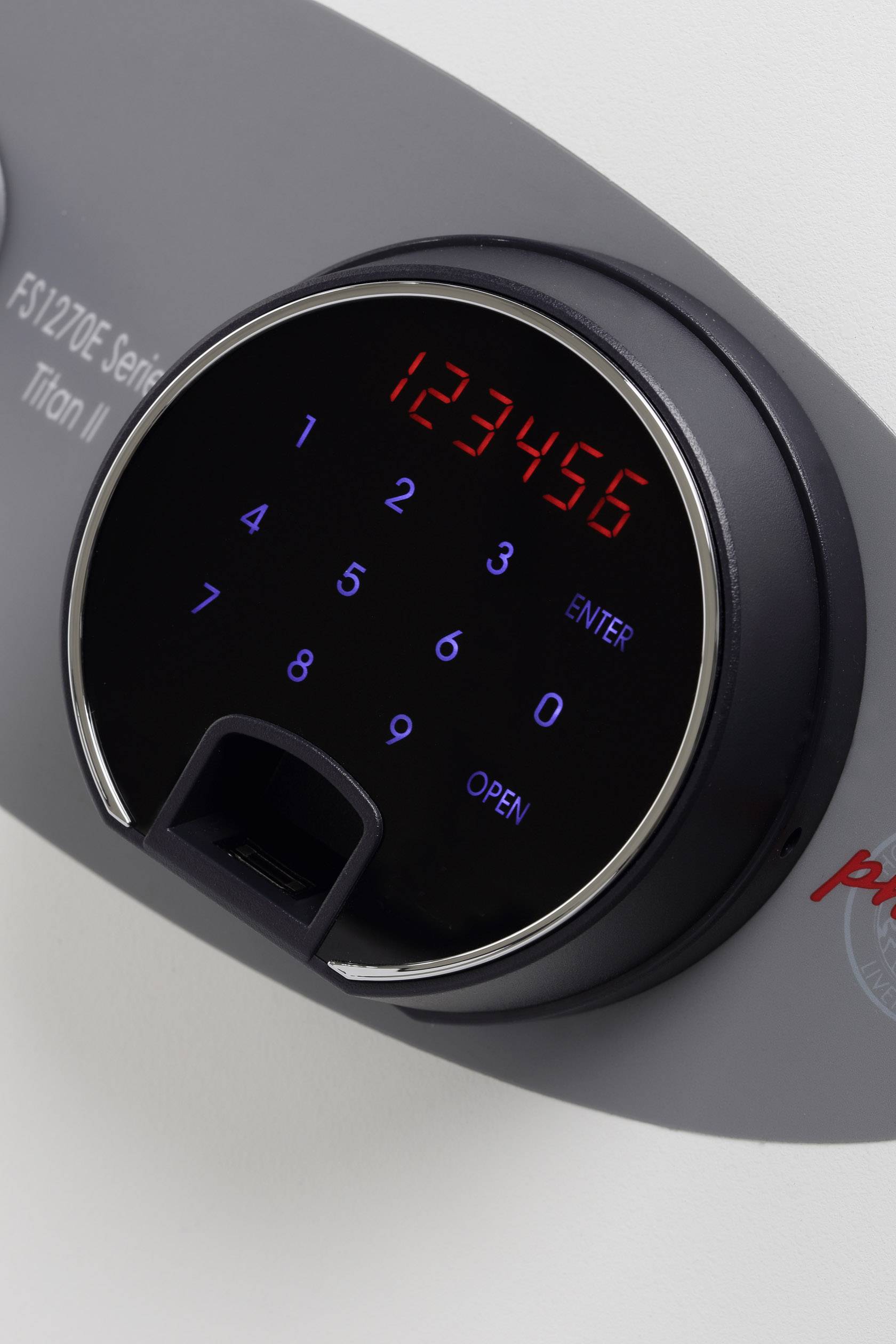Elektronisches Schloss mit digitaler Anzeige. Zeigt '123456' in Rot. Darunter blaue Tasten und ein 'ENTER' und 'OPEN'-Feld.
