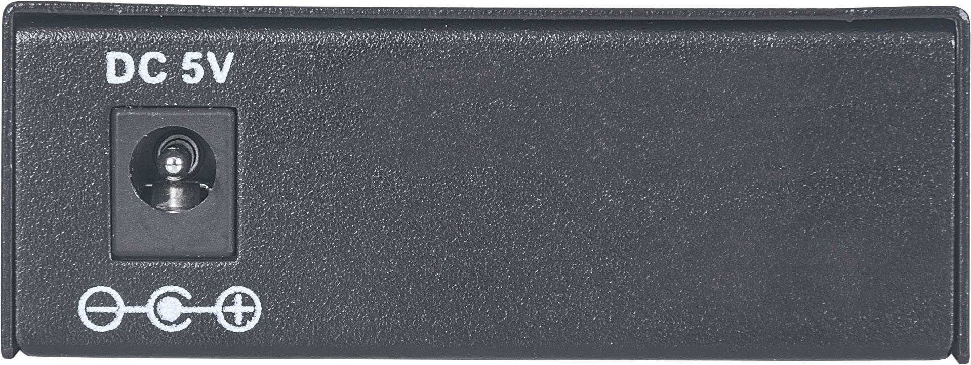 Schwarzes Gehäuse mit 'DC 5V' und einem Stromanschluss. Kleine Symbole zeigen Polarität an: Minus, Kreis, Plus.