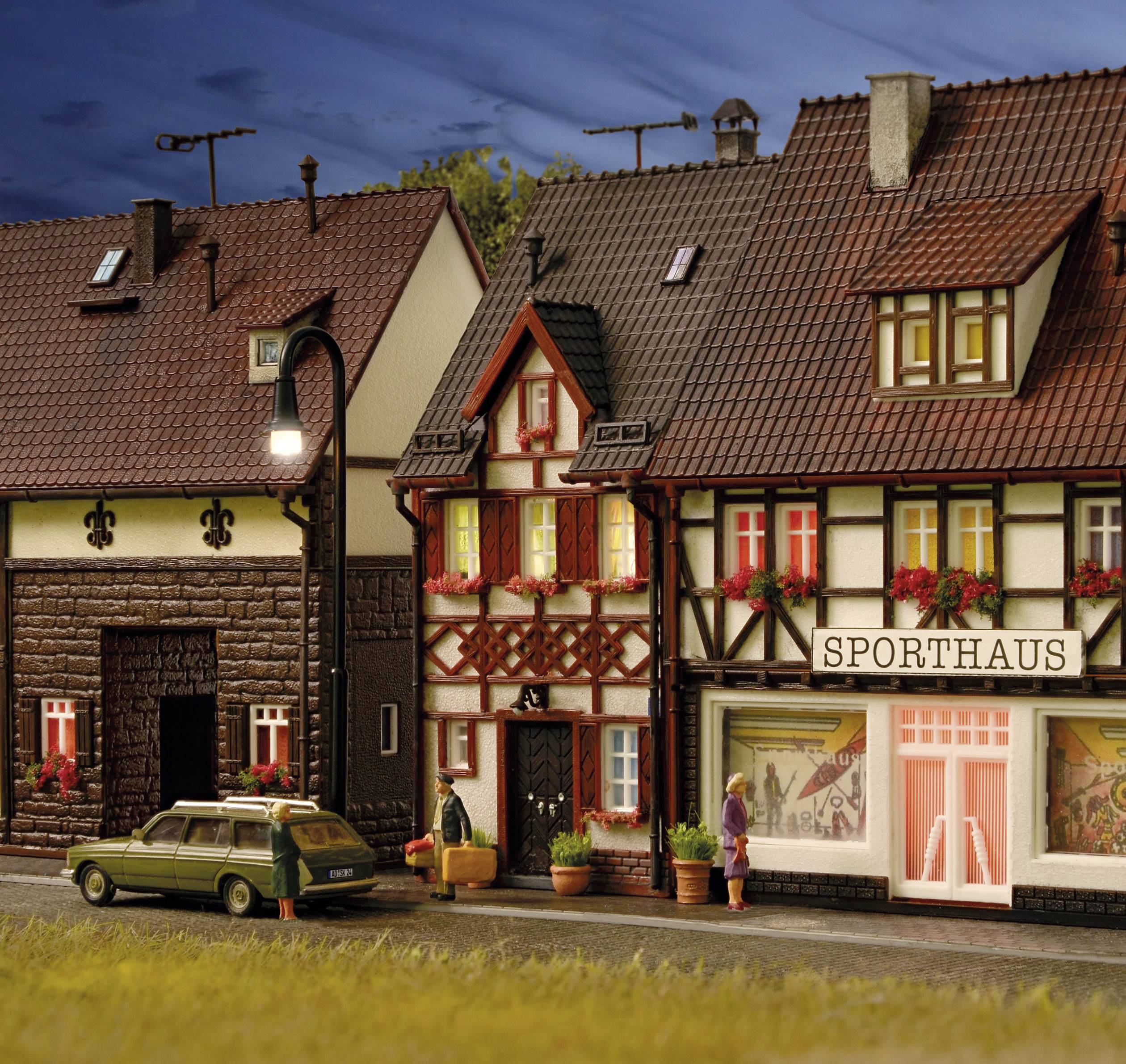 Ein Miniaturmodell einer Straße mit Fachwerkhäusern. Eins der Gebäude ist ein 'Sporthaus', davor steht ein alter grüner Kombi.