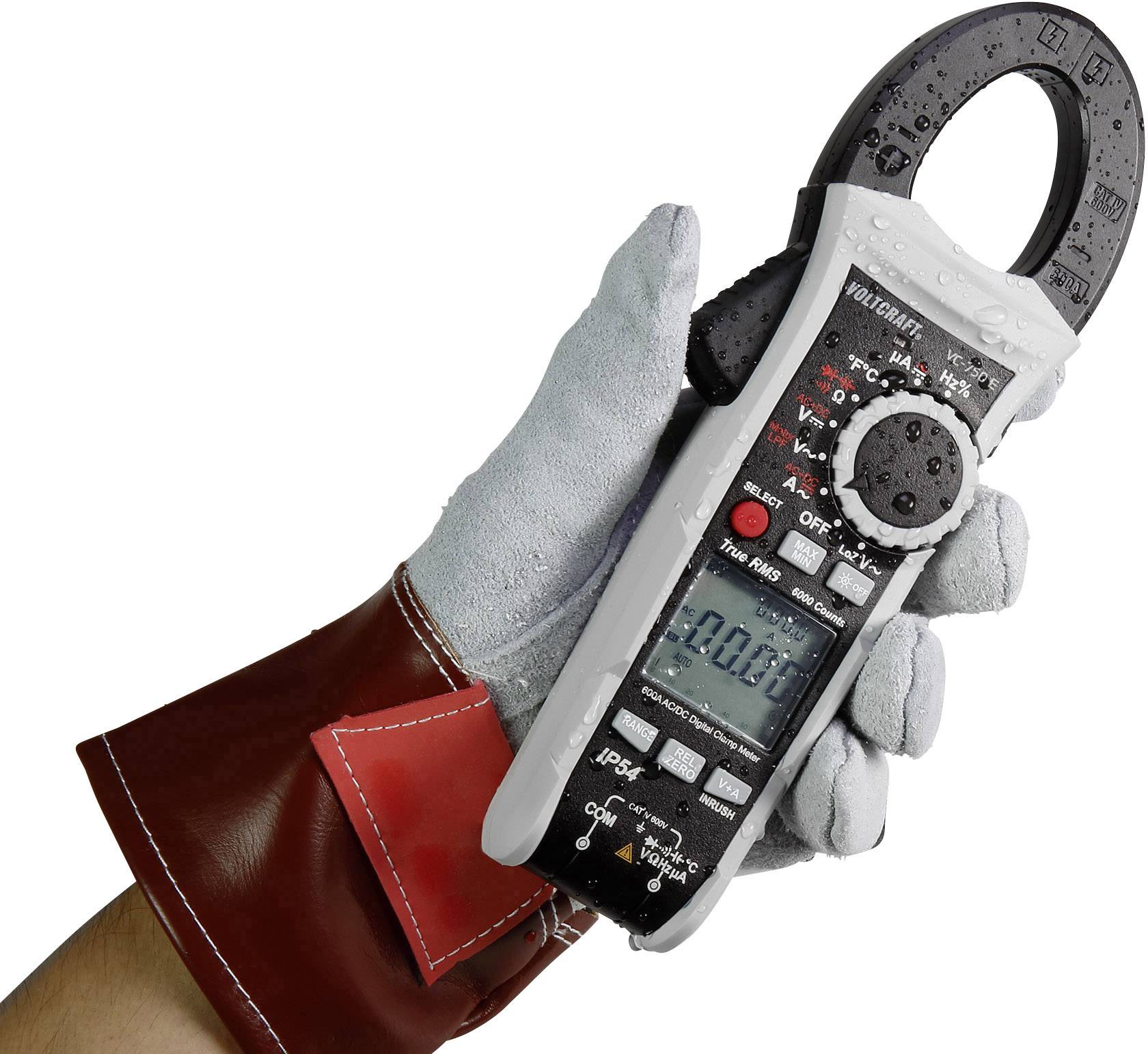 Eine behandschuhte Hand hält ein digitales Zangenmultimeter. Das Display zeigt '0.00'. Das Gerät misst elektrische Werte.