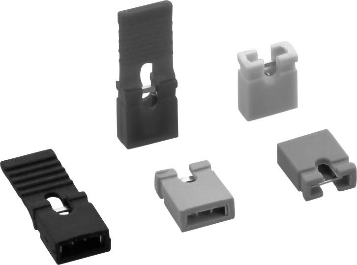 Fünf Jumperkappen in verschiedenen Formen und Farben für die Konfiguration von Computer-Mainboards.