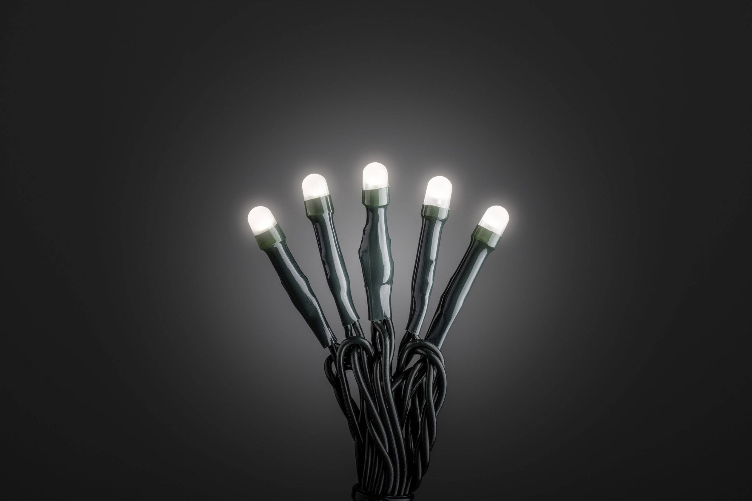 Fünf leuchtende LED-Lichter in einer dunklen Umgebung, die nach oben ragen und ein dezentralisiertes Leuchten erzeugen.