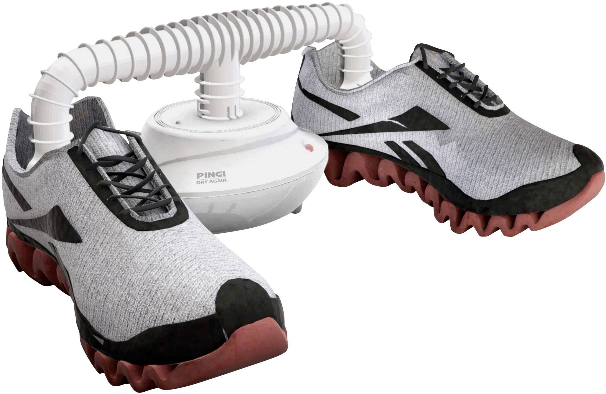 Ein weißer Schuh- und Stiefeltrockner mit zwei flexible Schläuche, die in grauen Sportschuhen stecken. Die Schuhe haben rote Sohlen.