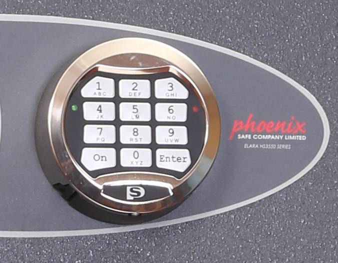 Elektronisches Schloss von 'phoenix safe company'. Runder Tastenblock mit Zahlen und 'Enter'-Taste, geeignet für Tresore.
