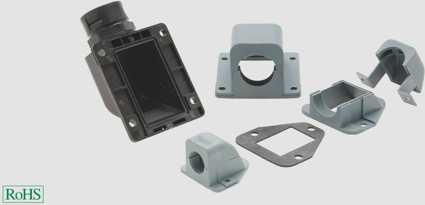 Verschiedene Gehäuseteile und eine Dichtung, möglicherweise für Elektronik oder Maschinenbau, auf weißem Hintergrund. RoHS-Logo unten links.