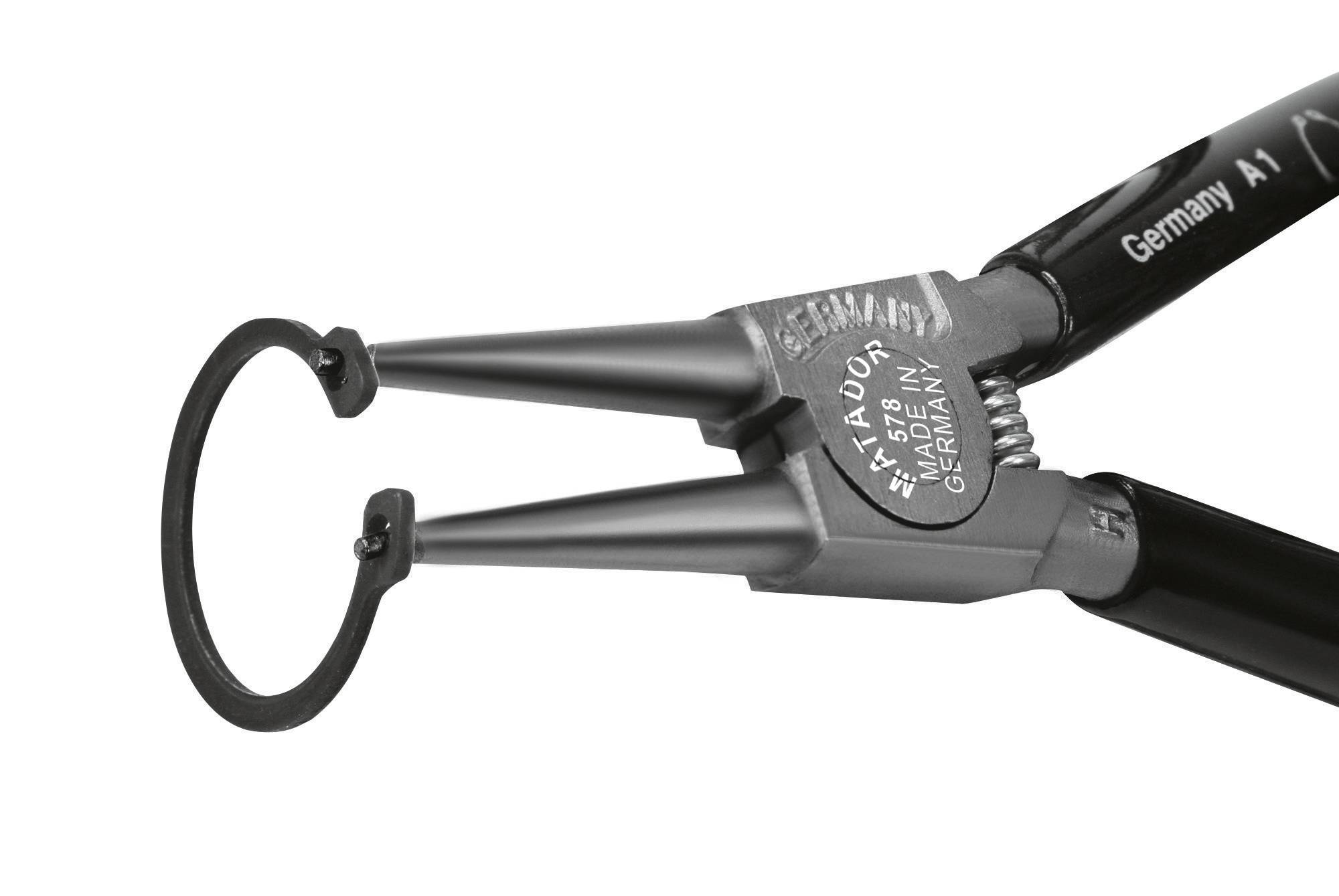 Zange mit rundem Ring an der Spitze, geeignet für präzises Greifen oder Halten kleiner Objekte, Oberfläche metallisch.