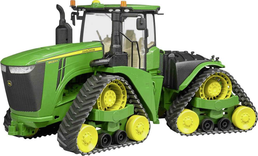 Ein grüner Traktor mit Raupenantrieb steht frontal zur Kamera. Er hat große gelbe Räder und ist auf Landwirtschaftsfelder spezialisiert.
