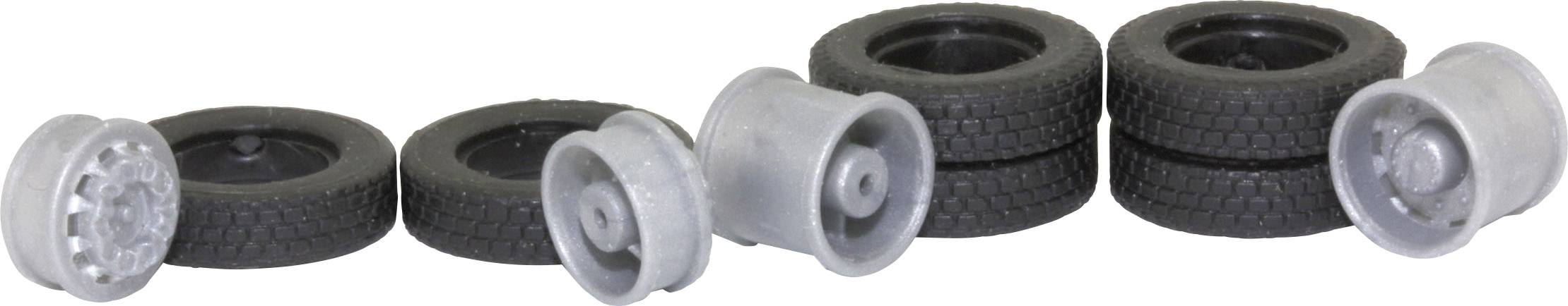 Vier Miniaturreifen und drei graue Felgen in verschiedenen Anordnungen