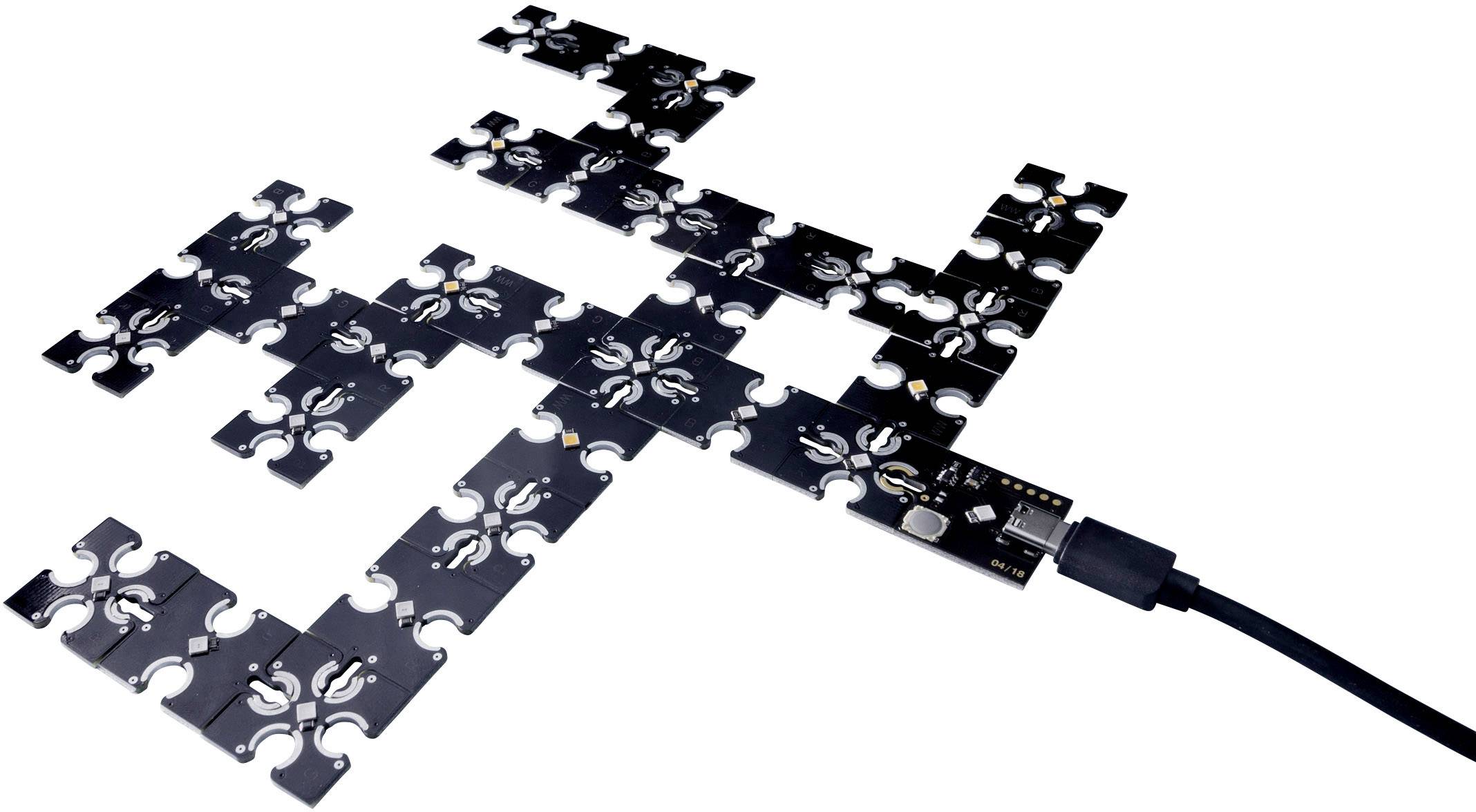 Ein modulares elektronisches Schaltkreis-Set mit schwarzen, rechteckigen Teilen, verbunden durch ein USB-Kabel.