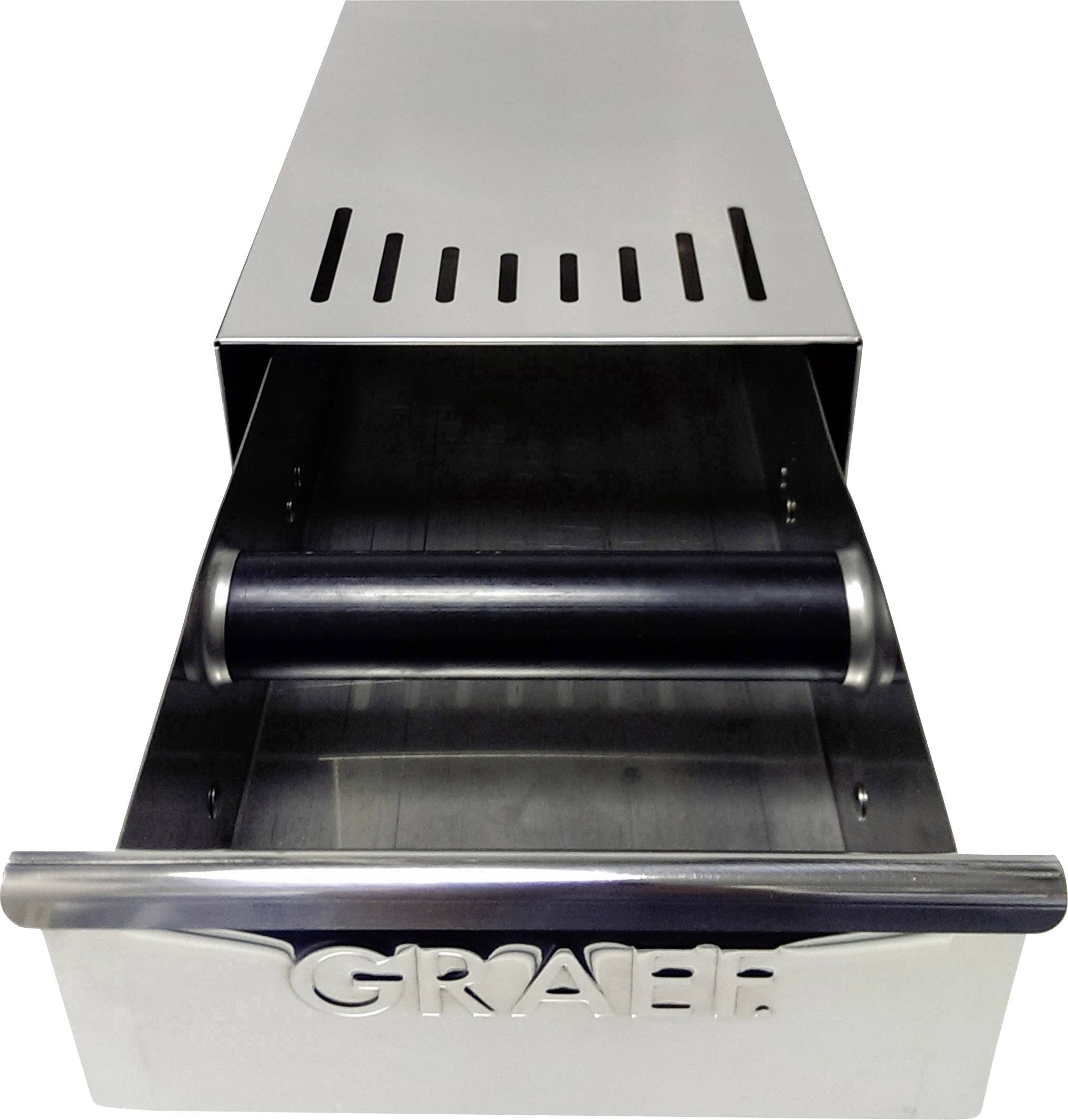 Ein hoher, rechteckiger silberner Metallbehälter mit Schlitzen auf der Oberseite und einem schwarzen Zylinder in der Mitte.