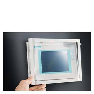 Hand hält ein kleines, quadratisches Touchscreen-Display an einer Wand. Das Display zeigt einen blauen Bildschirm ohne Inhalt.