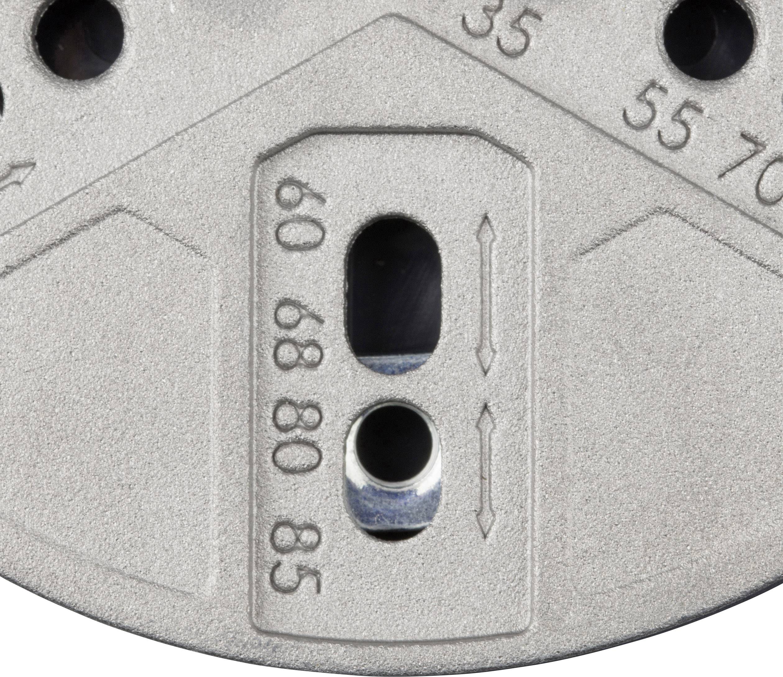 Ein silbernes Metallteil mit Beschriftungen: '35', '55', '70', '60', '80', '85'. Zwei senkrechte Schlitze befinden sich in der Mitte.