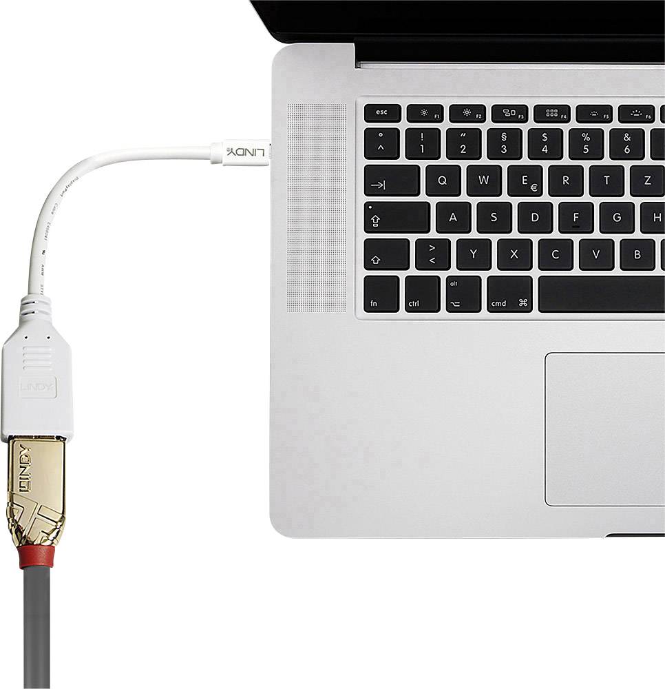 Ein Kabel ist mit einem Laptop verbunden, das peripheres Gerät anschließt. Tastatur und Touchpad sind sichtbar.