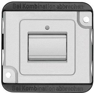 Lichtschalter mit der Aufschrift 'Bei Kombination abbrechen'. Rechteckige Form mit zentralem Kippschalter und Schrauben an den Ecken.