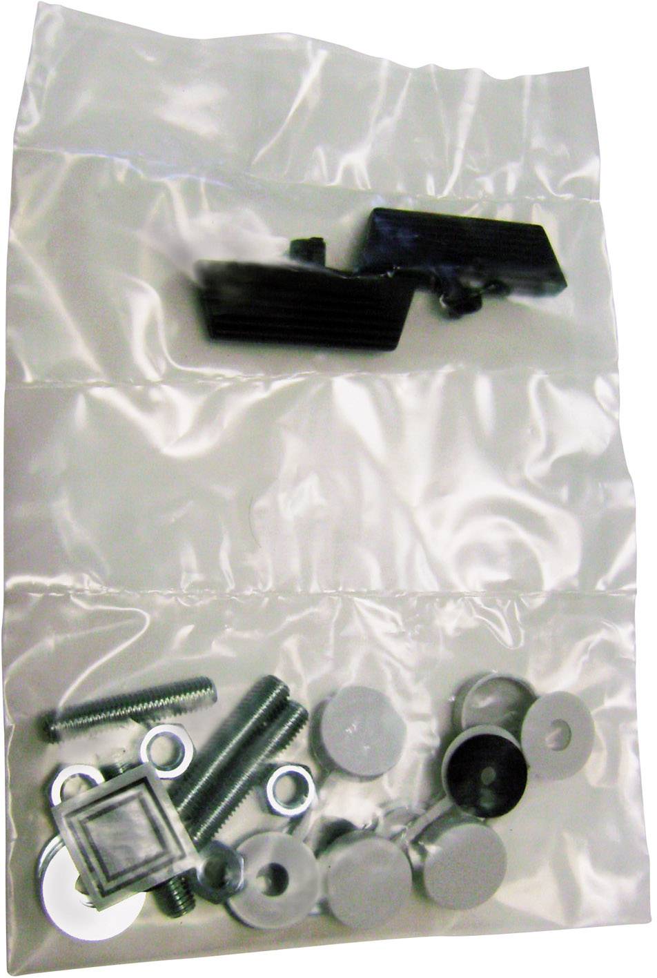 Eine transparente Plastikverpackung enthält schwarze Kunststoffteile, Schrauben und Unterlegscheiben.