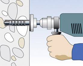 Eine Hand hält einen Bohrhammer, der in eine Wand mit unregelmäßigen Steinen bohrt.
