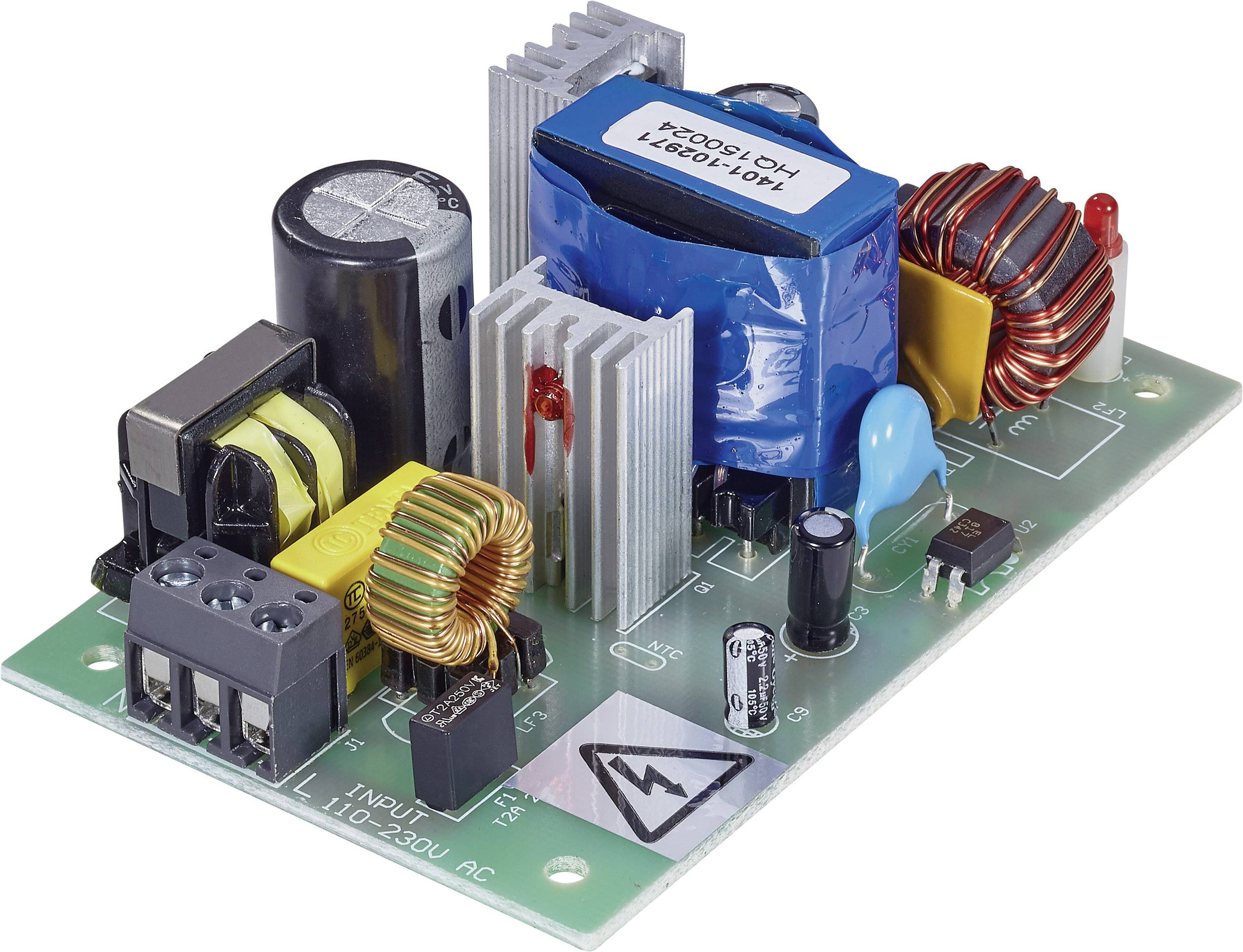 Elektronische Leiterplatte mit verschiedenen Bauteilen wie Kondensatoren, Spulen und Kühlkörper, die auf einer grünen Platine montiert sind.