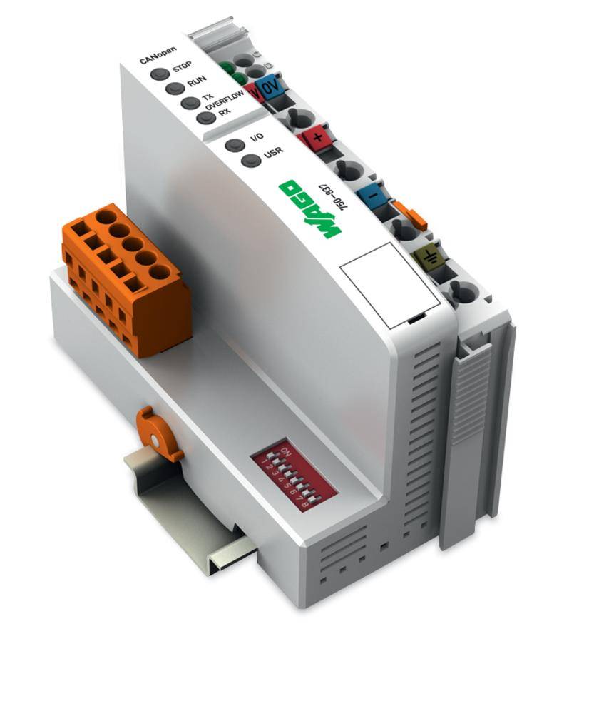 Ein graues elektronisches Modul mit mehreren Anschlüssen, farbigen Steckverbindern und einer LED-Anzeige, wird als Steuergerät verwendet.