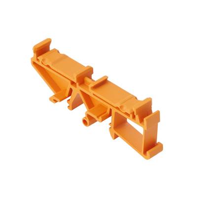 Ein orangefarbenes Kunststoffteil mit geometrischen Formen und Halterungen, möglicherweise ein technisches Bauteil oder eine Halterung.