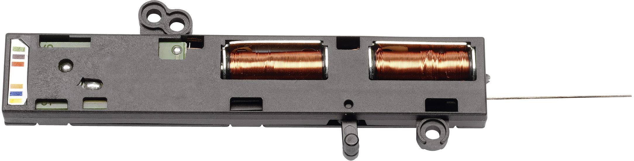 Elektronische Spule in einem schwarzen Gehäuse mit zwei sichtbaren Kupferspulen, möglicherweise ein Bestandteil eines technischen Geräts.