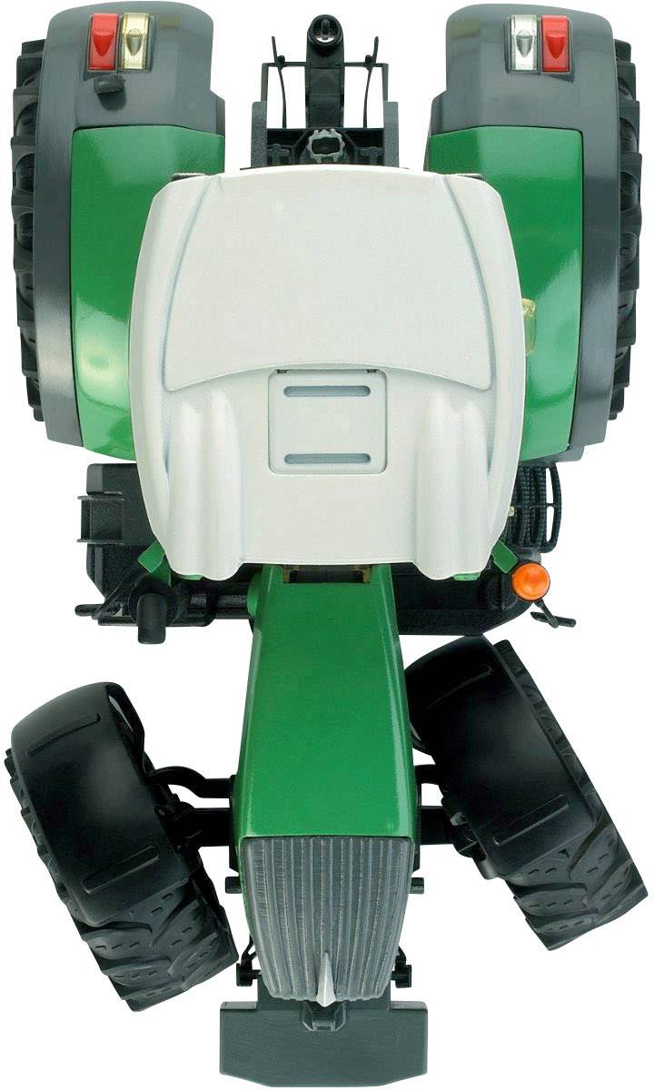 Ein grüner Spielzeugtraktor von oben fotografiert, zeigt Details wie Reifen und Fahrerkabine in der Mitte des Bildes.