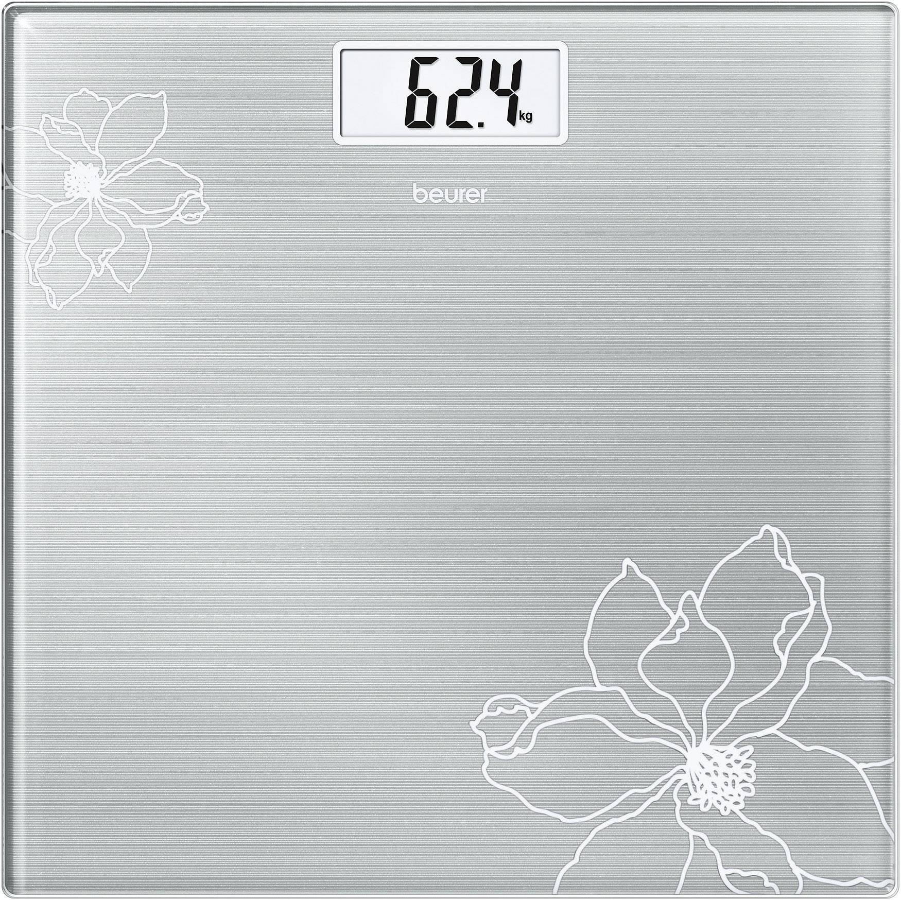 Digitale Waage mit silberner Oberfläche und Blumenmuster zeigt 62,4 kg.