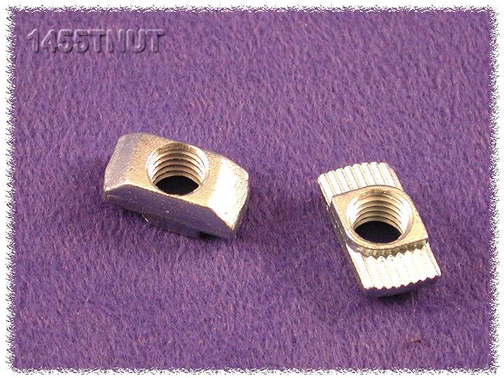 Zwei T-Nuten-Steine aus Metall auf lila Hintergrund, einer liegt flach und der andere steht aufrecht, zeigen die Rillenstruktur.