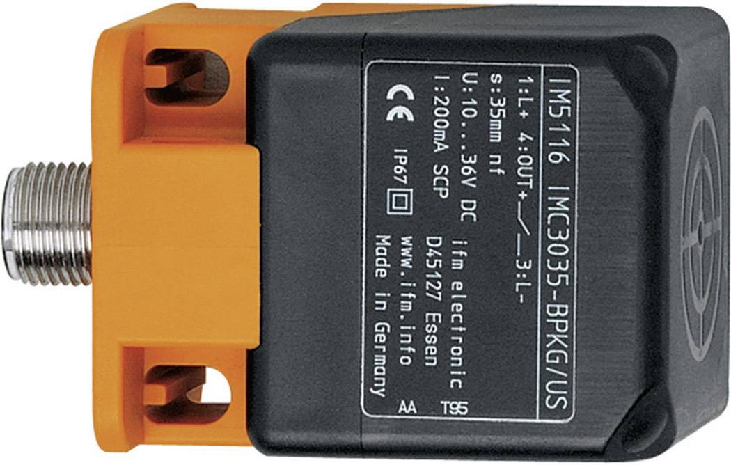 Ein rechteckiger, elektronischer Sensor mit orangefarbenem Gehäuse und schwarzer Beschriftung, zeigt technische Spezifikationen und Anschlussdetails.
