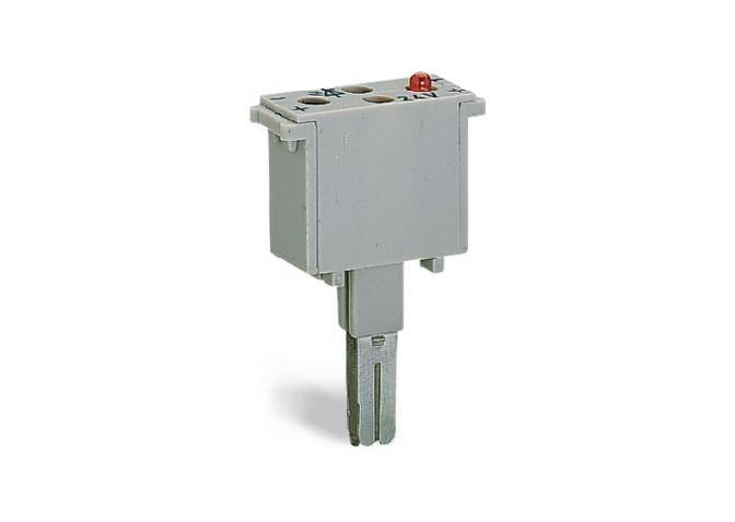 Ein graues elektrisches Bauteil mit zwei Anschlüssen und einem kleinen roten Knopf oben, möglicherweise ein Schalter oder Relais.