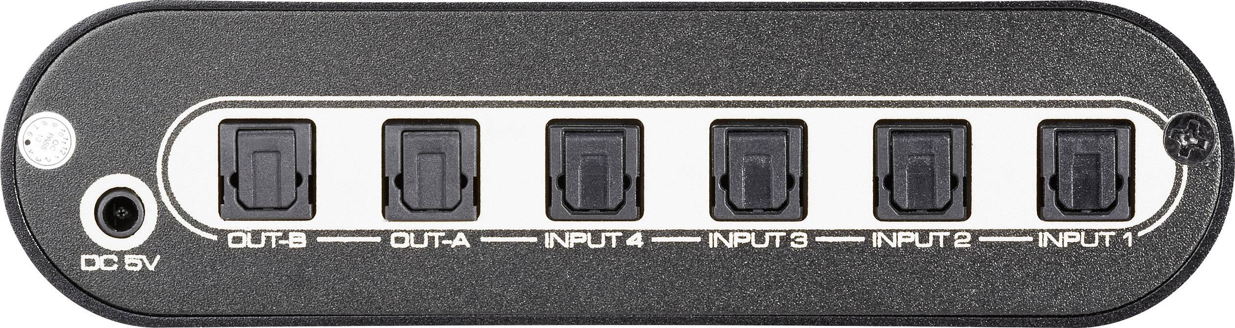 Ein schwarzes elektronisches Gerät mit sechs Anschlüssen, zwei markiert als 'OUT' und vier als 'INPUT', sowie eine DC 5V Strombuchse.