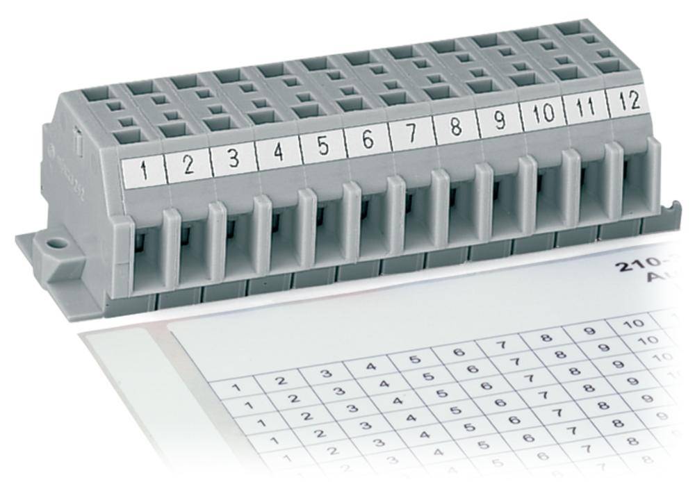 Klemmleiste mit Nummerierungen 1 bis 12, zur Organisation elektrischer Anschlüsse, daneben ein beschriftetes Diagramm auf Papier.