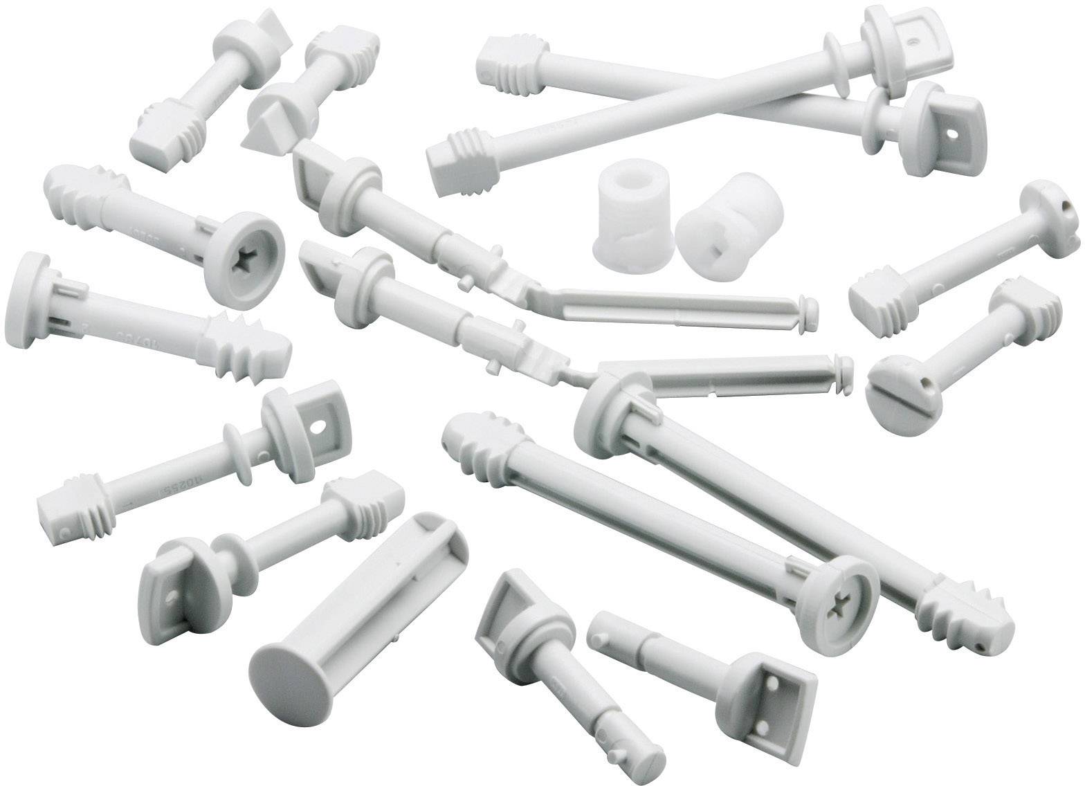 Mehrere weiße Kunststoff-Schraubdübel in verschiedenen Größen und Formen, auf weißem Hintergrund verstreut.