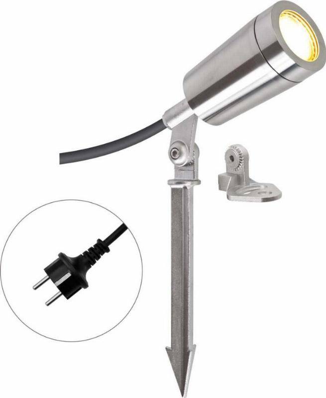 Ein silberner LED-Gartenstrahler mit Erdspieß und Netzstecker. Im Hintergrund eine Wandhalterung für alternative Montage.
