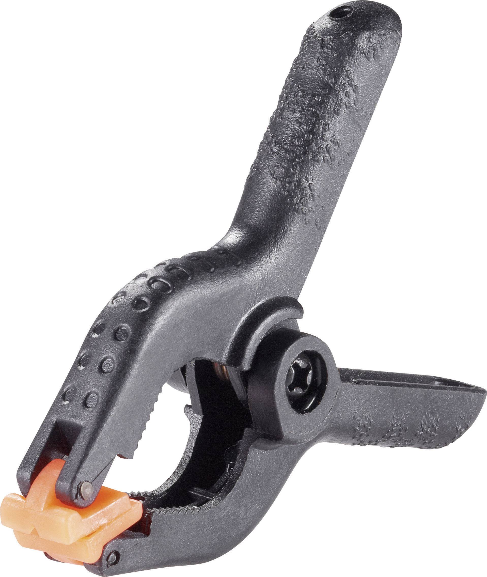 Schwarze Federzwinge mit orangefarbenen Spitzen, aus Kunststoff, typische Werkstatt- oder Hobbywerkzeug zum Fixieren von Materialien.