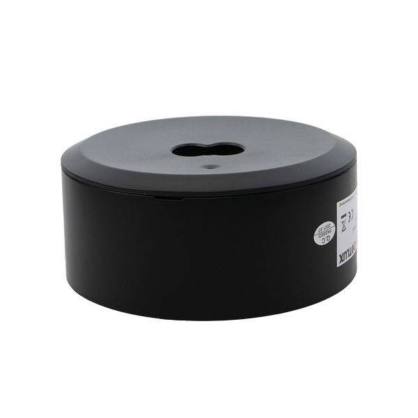 Schwarze runde Kunststoffbox mit einem zentralen Loch auf der Oberseite.