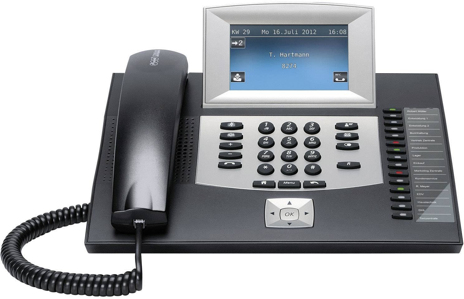 Schwarzes Telefon mit Display zeigt Datum '16. Juli 2012' und Name 'T. Hartmann'. Tastatur und Hörer in Vordergrund.