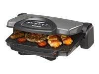 Offener Tischgrill mit elektrischem Antrieb und Lebensmittel, die auf der flachen unteren Platte garen.