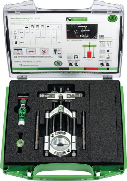 Ein Werkzeugset in einem schwarzen Schaumstoffkoffer, das einen mechanischen Abzieher und eine Tube Schmiermittel enthält. Ein Anleitungsblatt ist im Deckel sichtbar.
