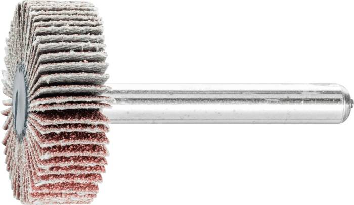 Eine Nahaufnahme eines Stapels kreisförmiger, strukturierter Scheiben auf einer Metallstange, die wie ein industrielles Werkzeug oder Bauteil aussehen.