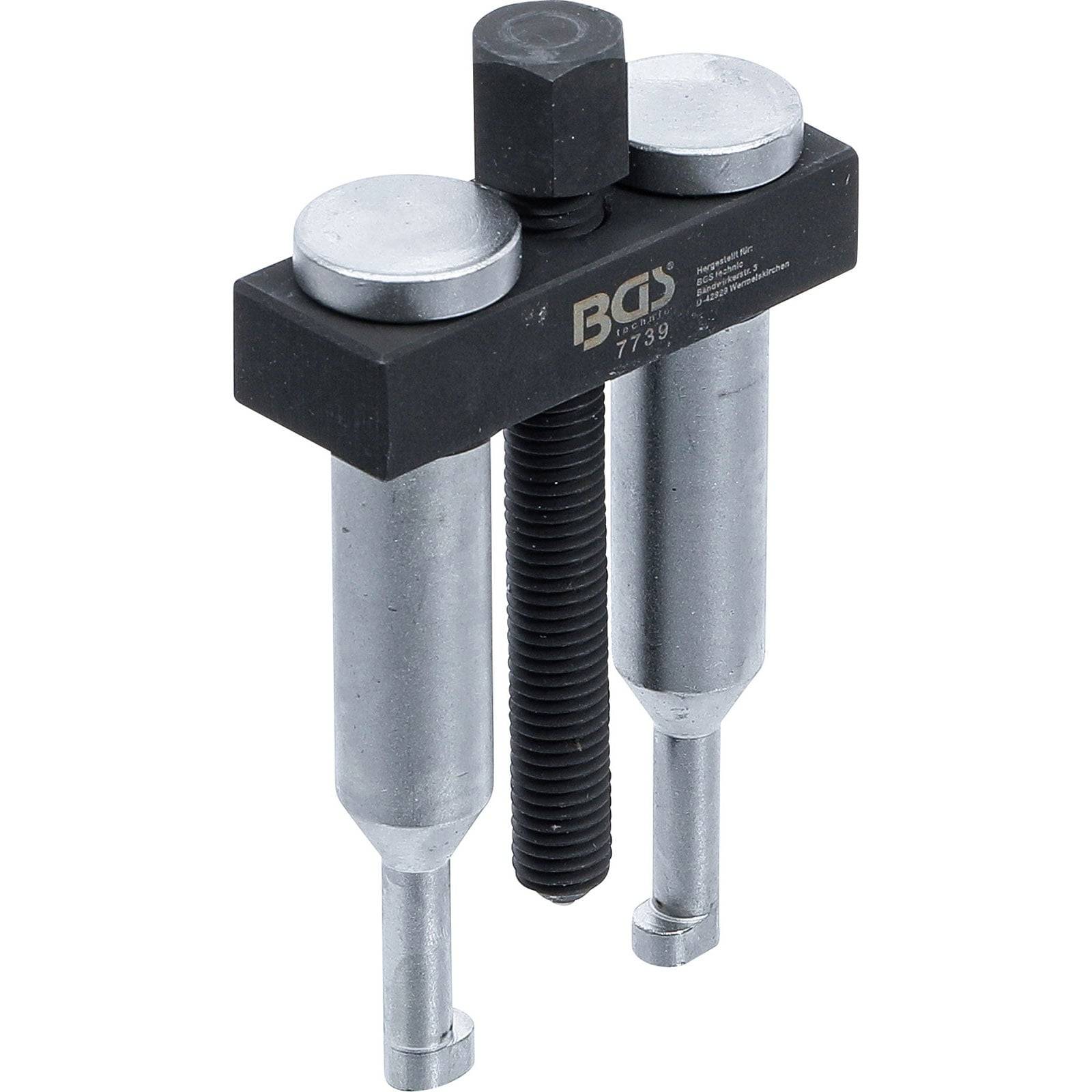 Ein zweibeiniger Auszieher mit einer schwarzen Metallquerachse, beschriftet mit BGS 7739, ausgestattet mit zwei silbernen zylindrischen Armen und einem zentralen Schraubenmechanismus.