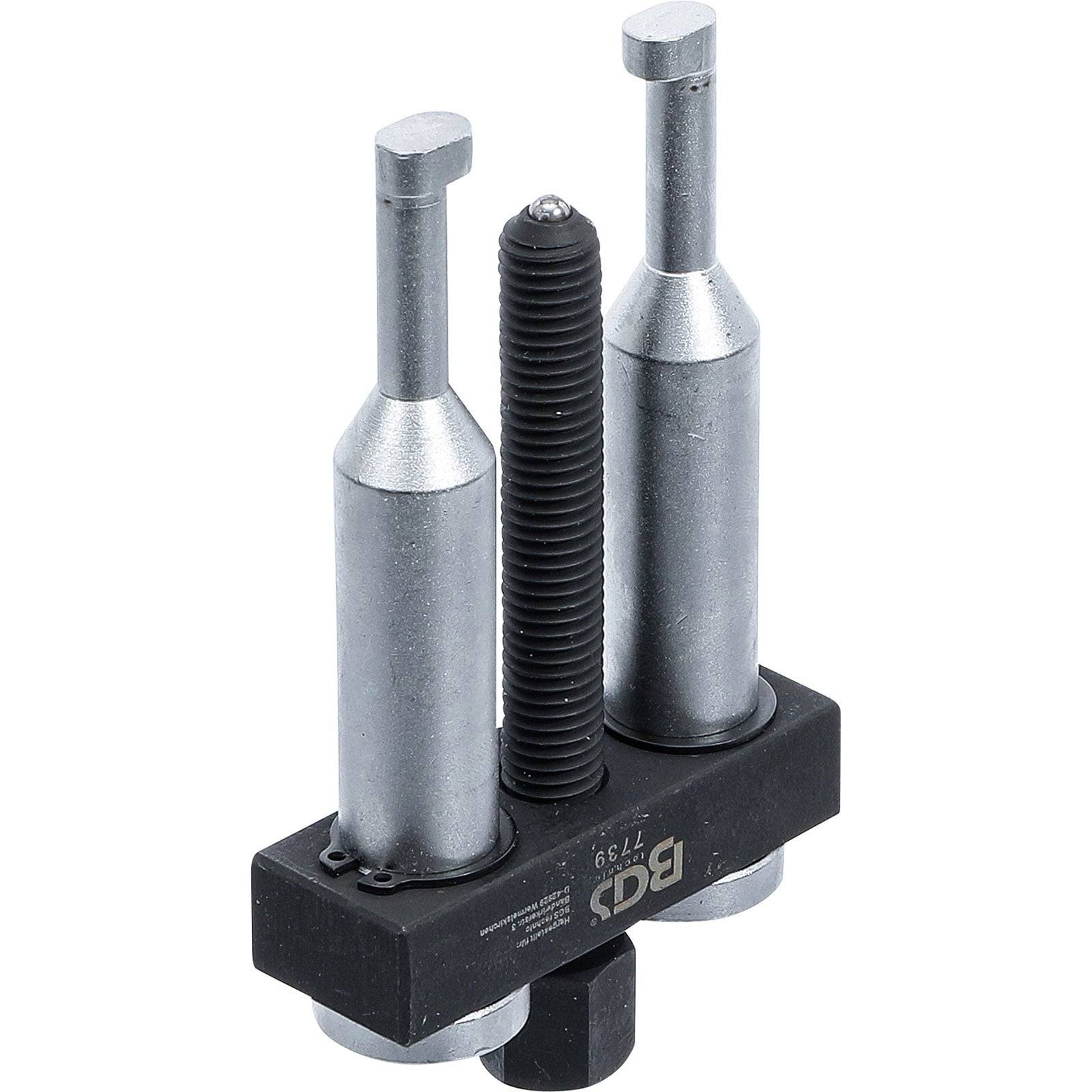 Ein Metallinstrument mit drei vertikalen zylindrischen Komponenten, die auf einer schwarzen Basis montiert sind, höchstwahrscheinlich für industrielle oder mechanische Zwecke verwendet.