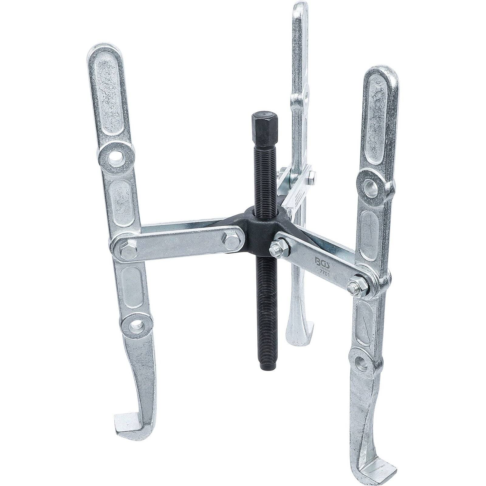 Ein Abzieher-Werkzeug aus Metall mit drei verstellbaren Armen und einer zentralen Schraube, das zum Entfernen von Zahnrädern oder Lagern aus Maschinenkomponenten verwendet wird.